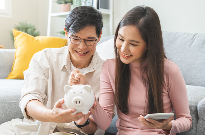 Couple with piggy bank retirement planning